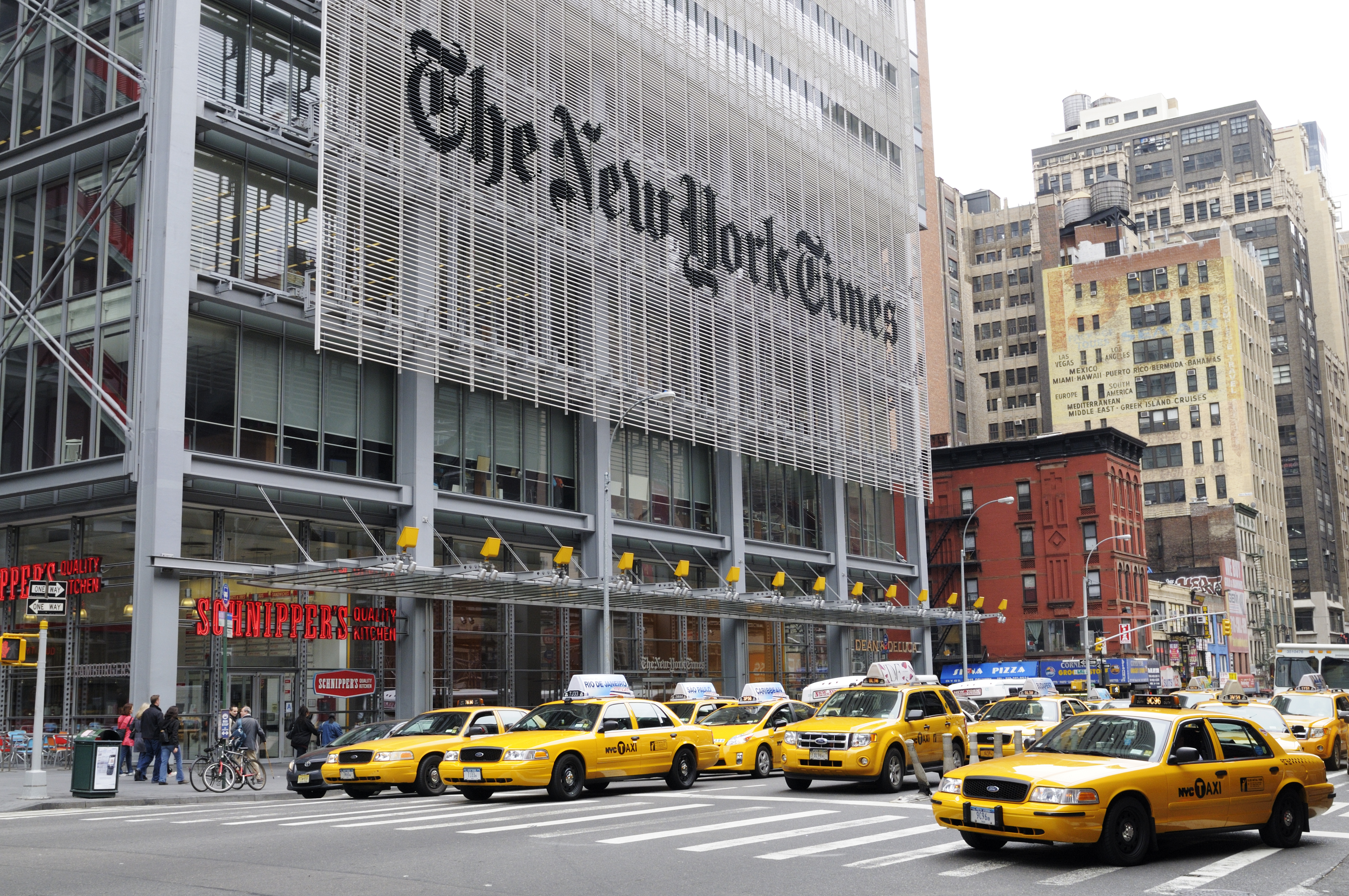 New York Times building and yellow cabs waiting at the lights